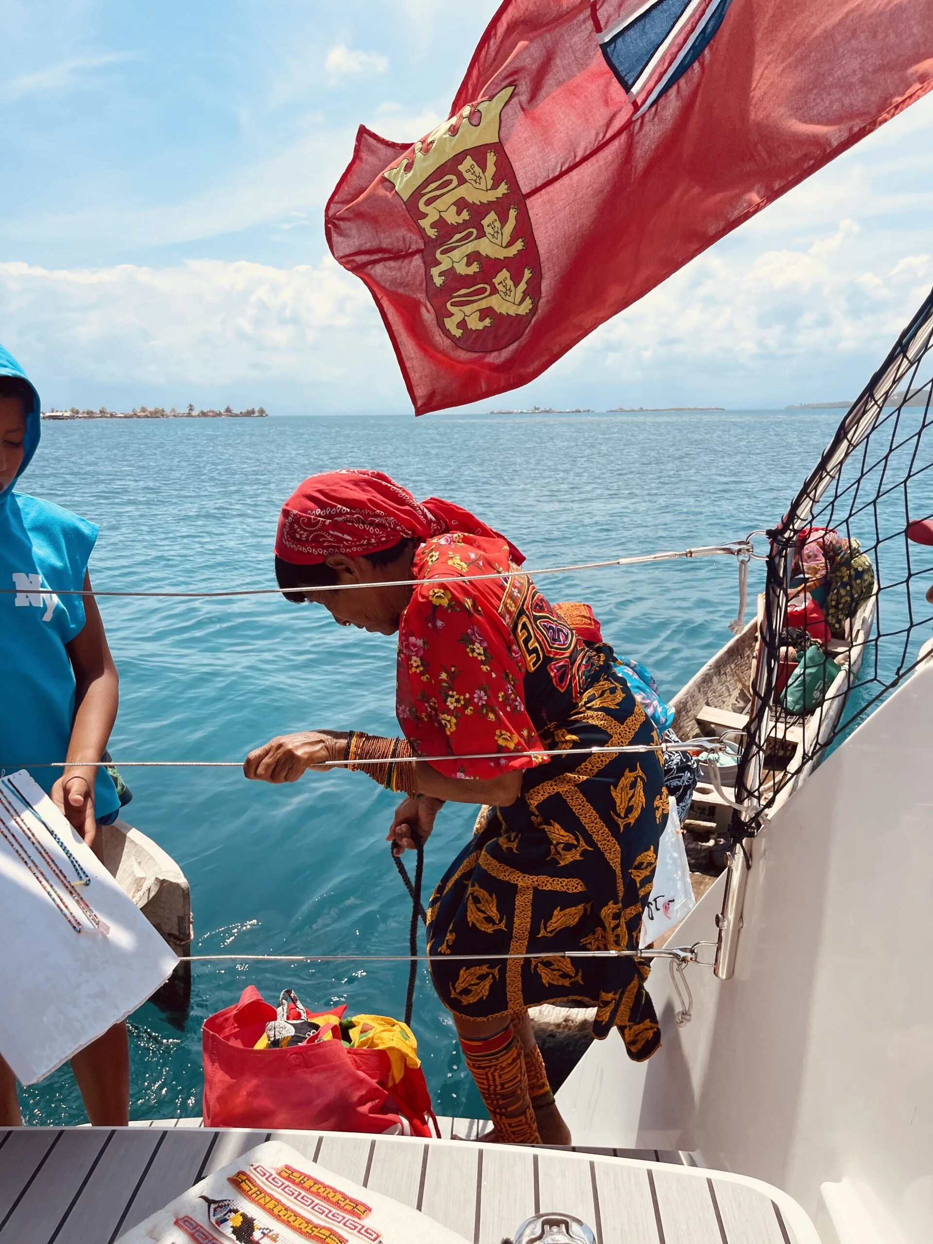 Twin-hull sailing vessel anchored in a quiet Rosario Islands cove