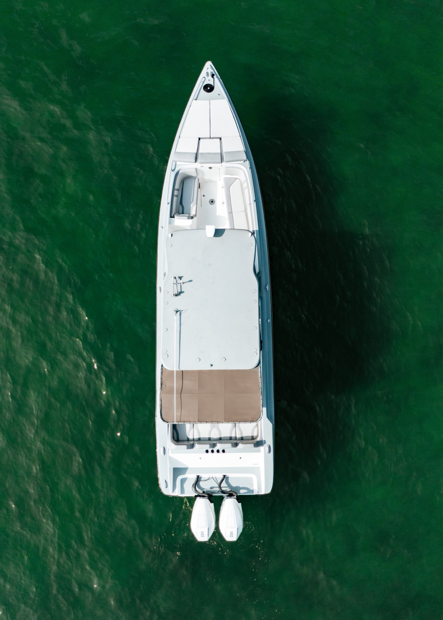 Aerial front view over emerald water