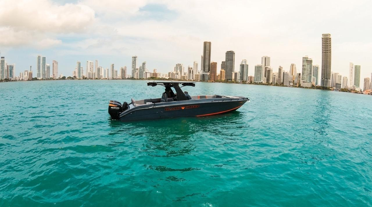 Luxury speedboat cruising Cartagena bay with the Bocagrande skyline