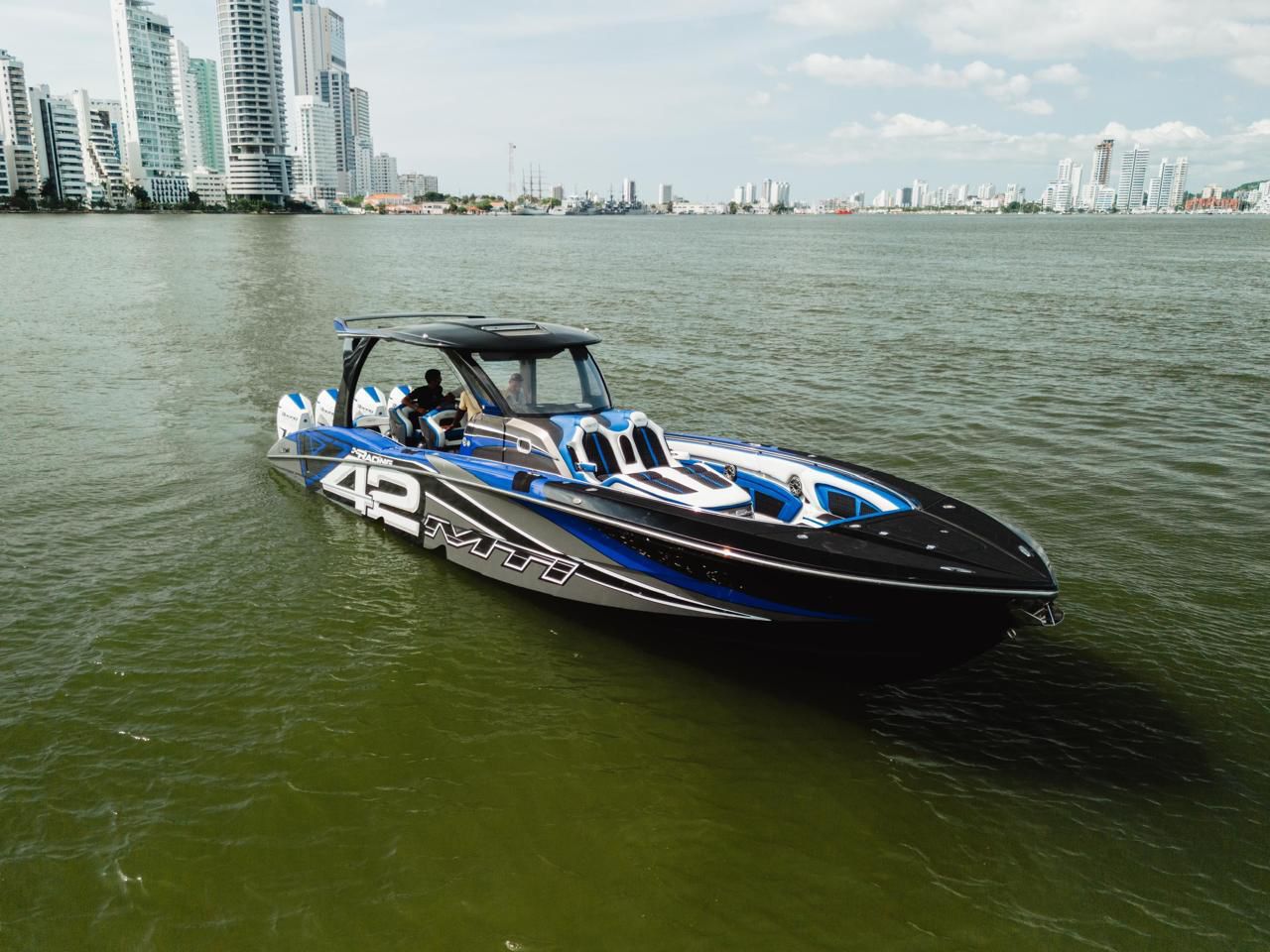 42 Racing speedboat running at speed in front of Cartagena skyline