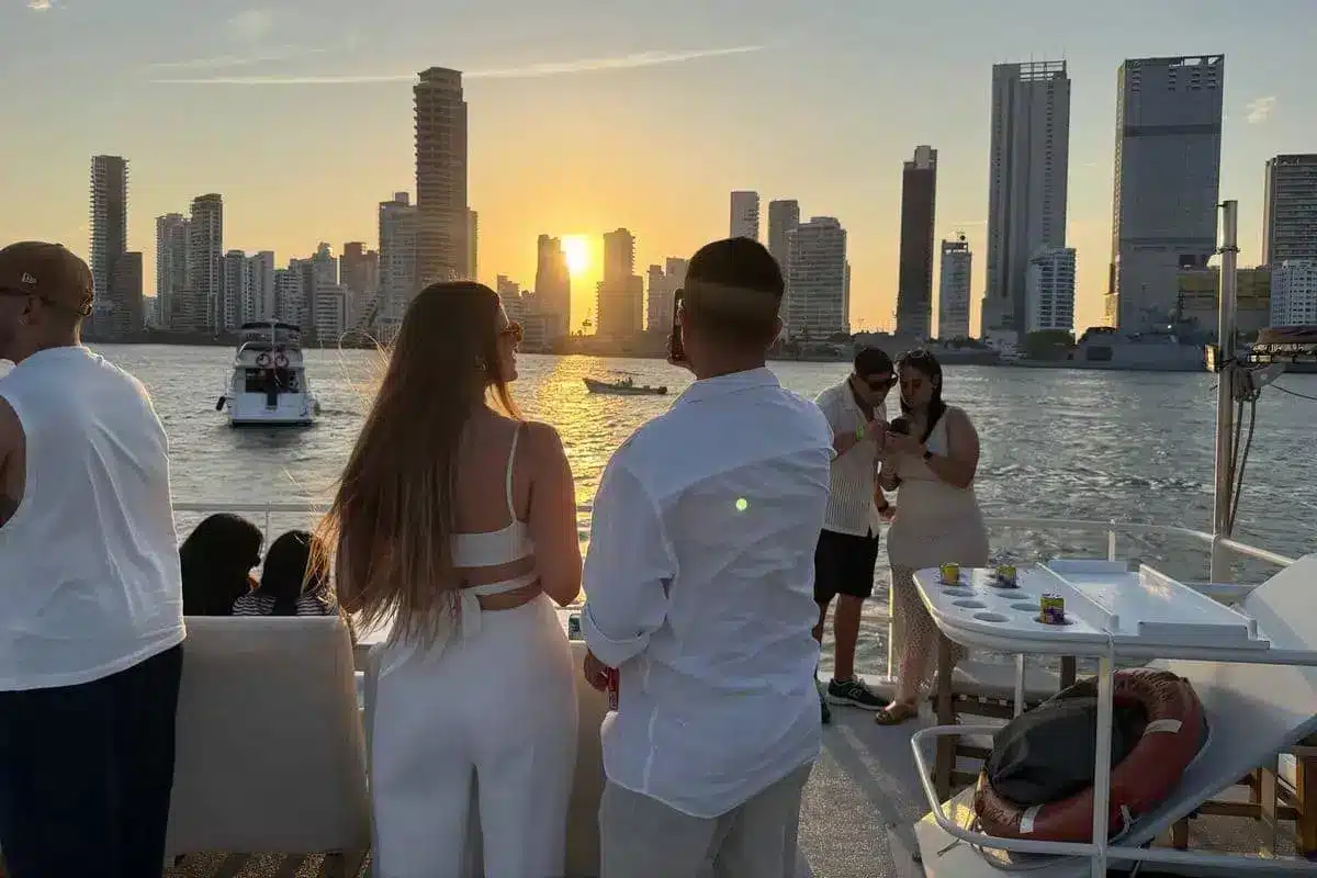 Guests watching the Bocagrande skyline at sunset from the 87 catamaran
