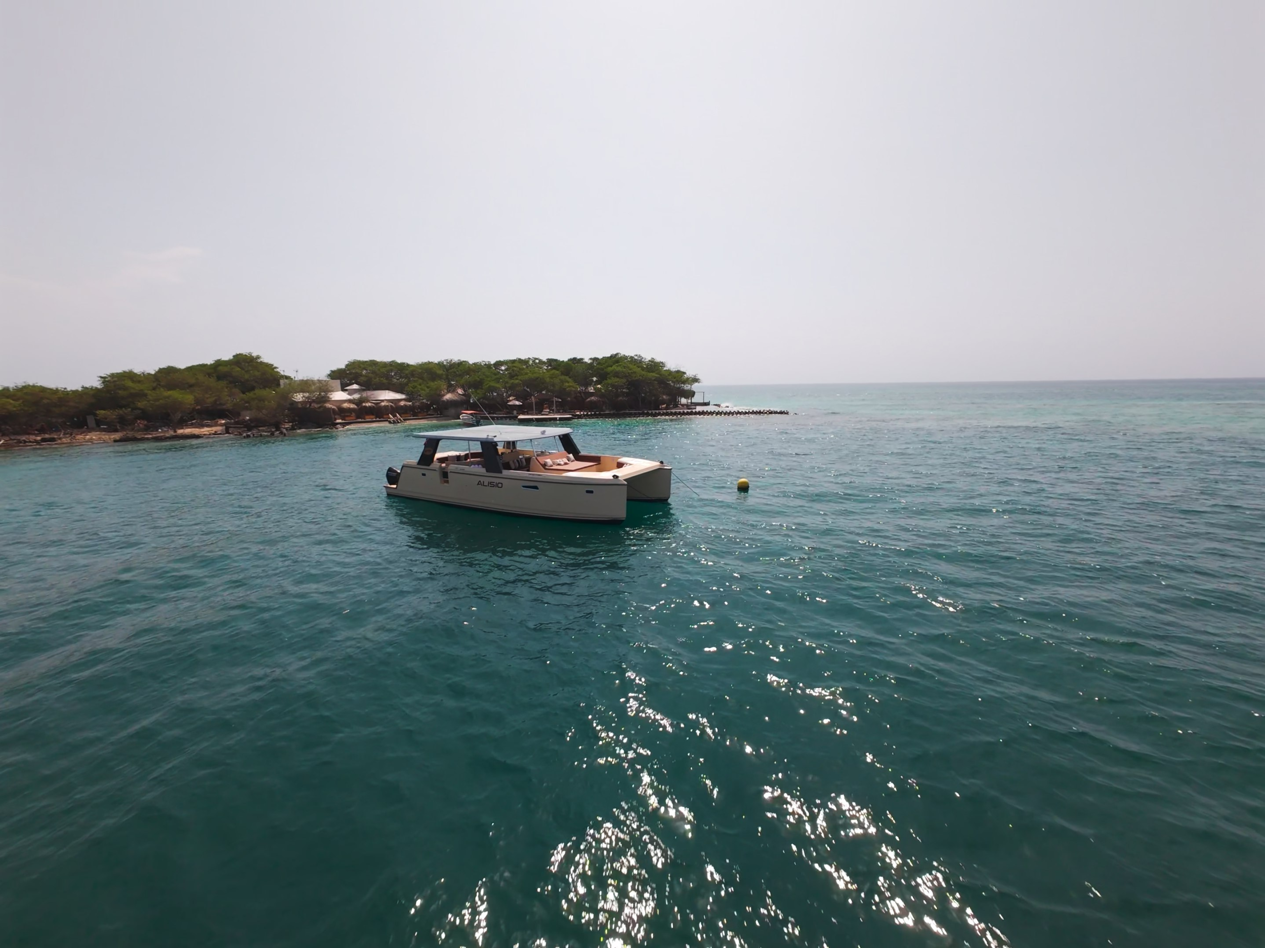 Alisio catamaran anchored off a Rosario Islands beach