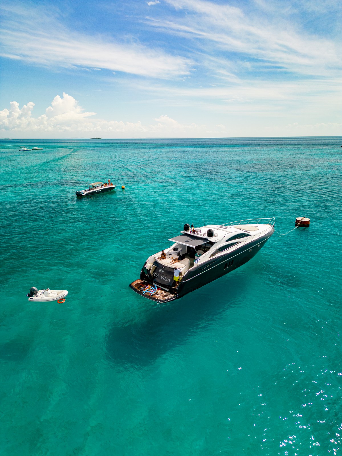 Guests aboard a luxury charter enjoying the Caribbean sunshine and turquoise water