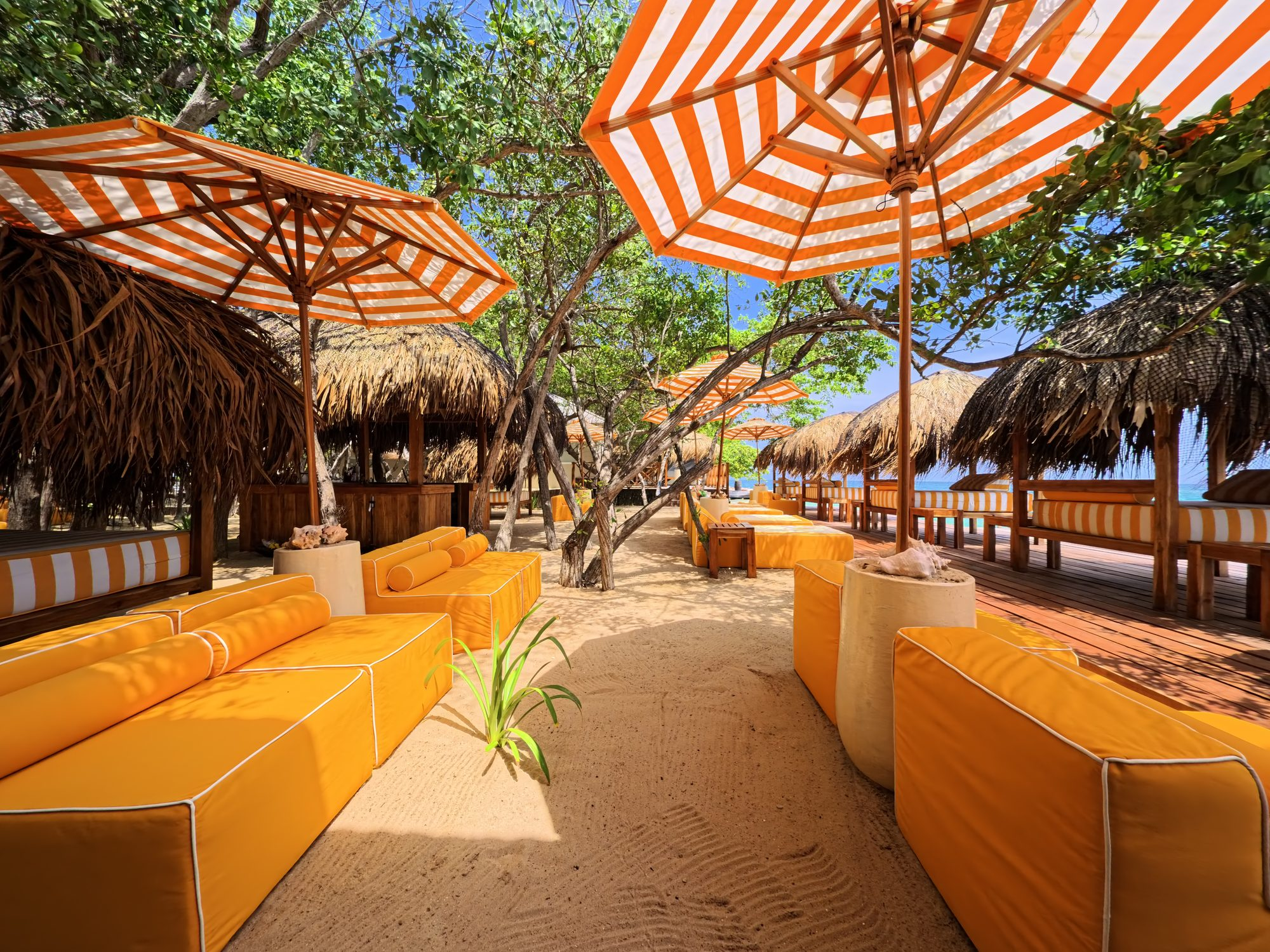Private island on Isla Grande — beach club dining under umbrellas