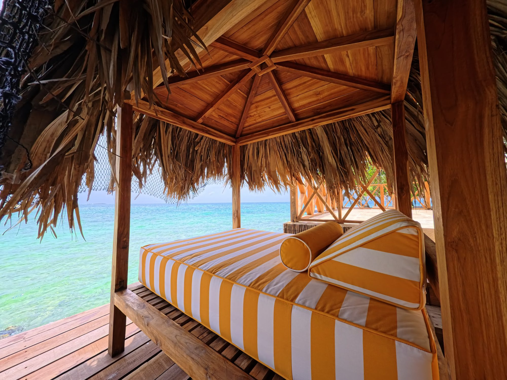 Private island on Isla Grande — beach club dining under umbrellas