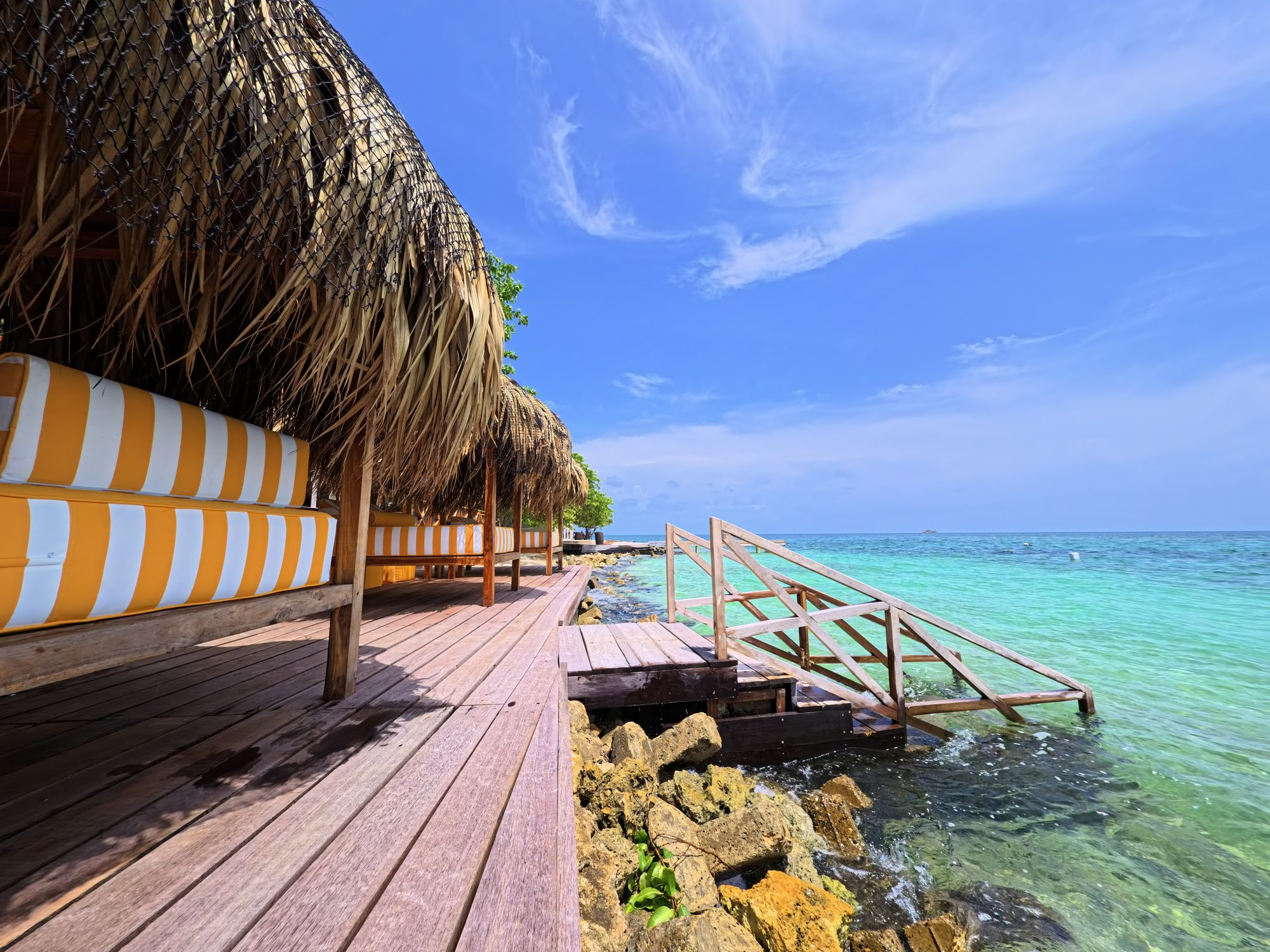 Private island on Isla Grande — beach club dining under umbrellas