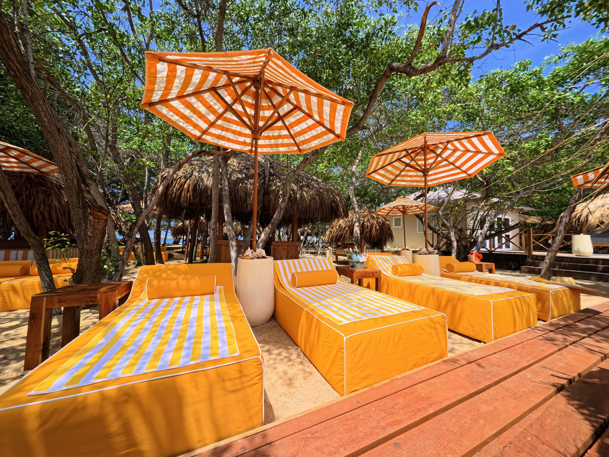 Private island on Isla Grande — beach club dining under umbrellas