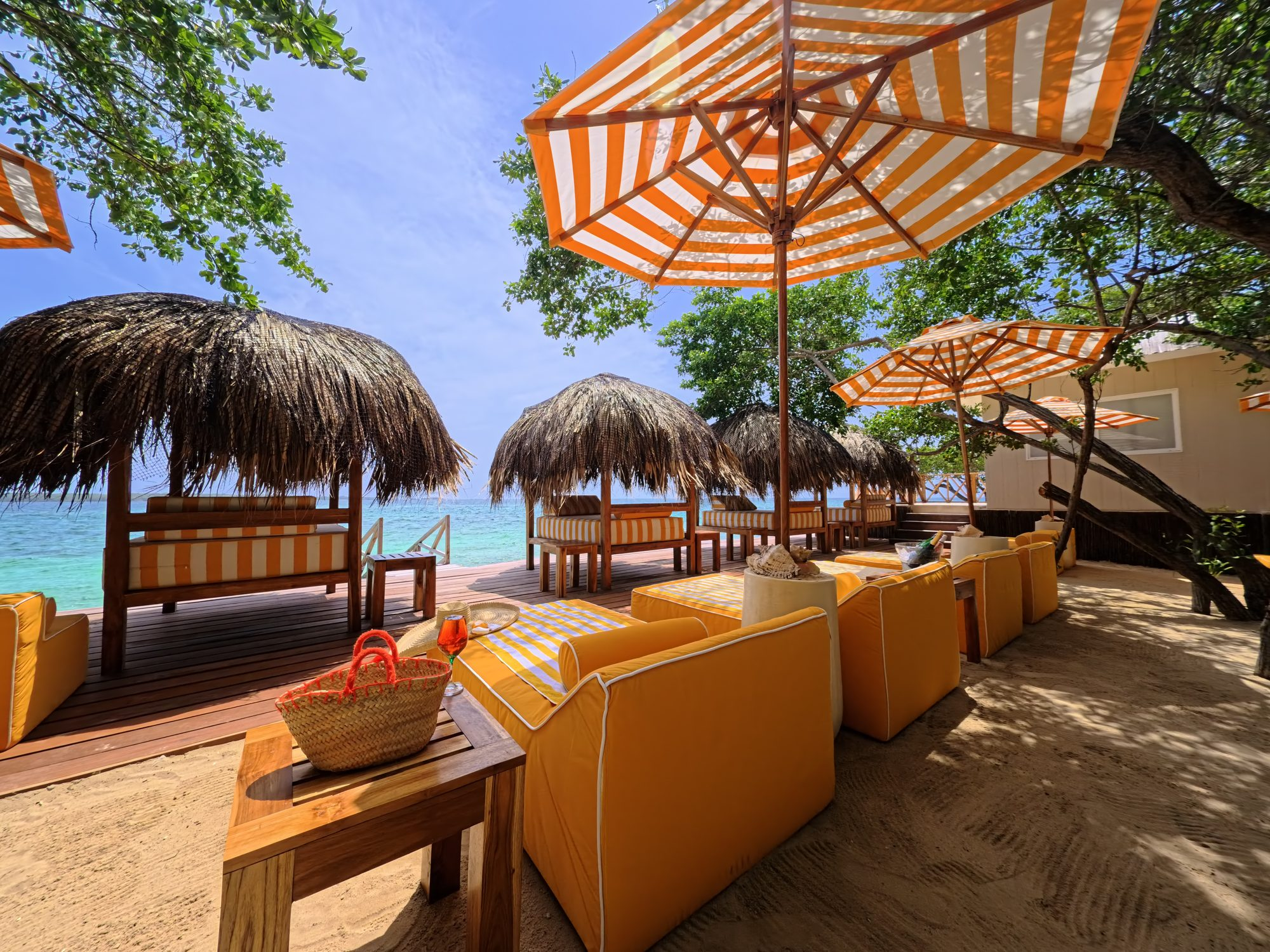 Private island on Isla Grande — beach club dining under umbrellas
