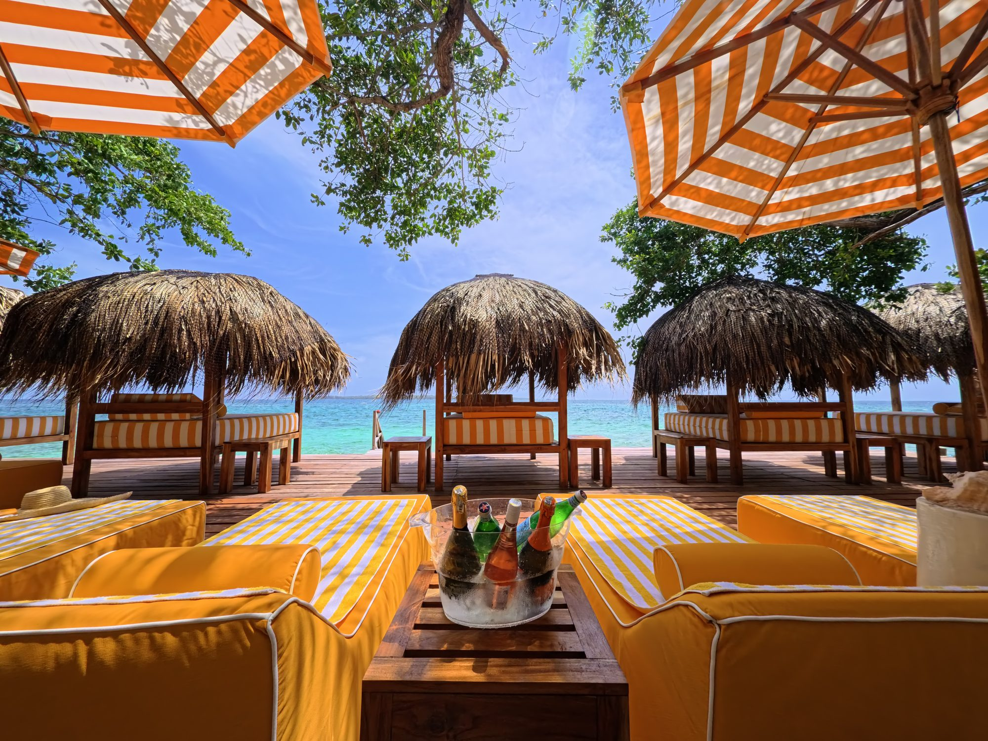 Private island on Isla Grande — beach club dining under umbrellas