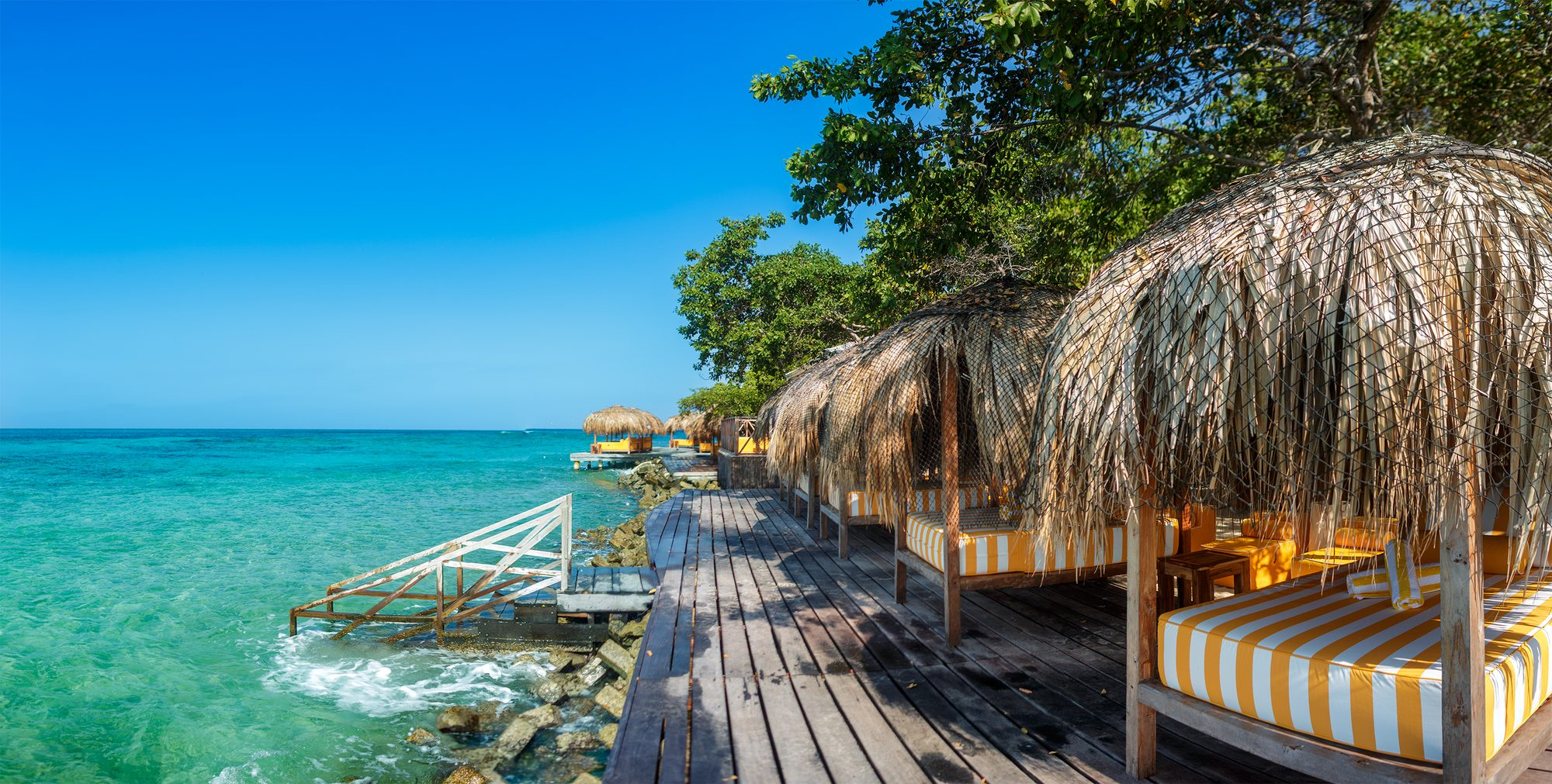 Private island on Isla Grande — beach club dining under umbrellas
