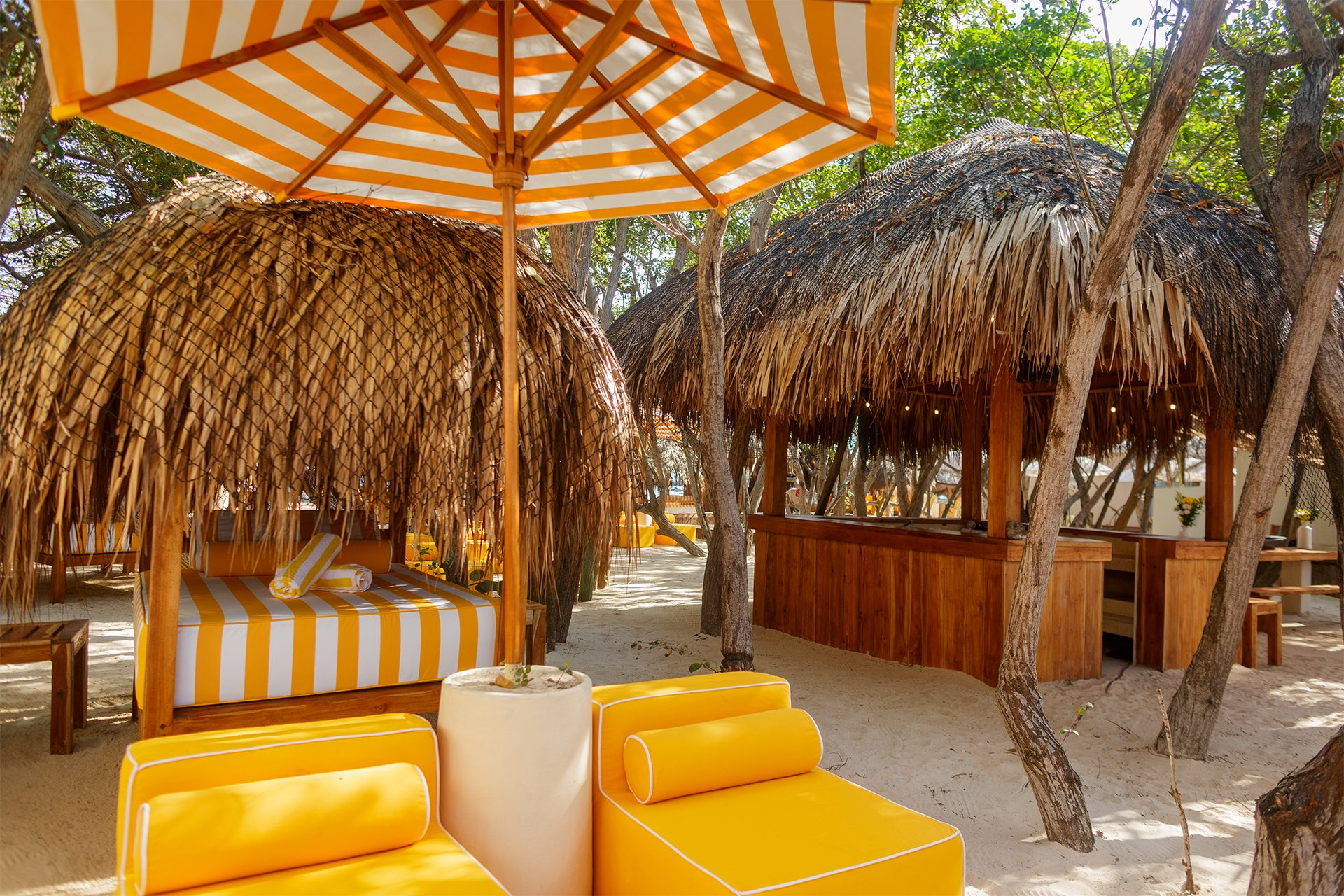 Private island on Isla Grande — beach club dining under umbrellas