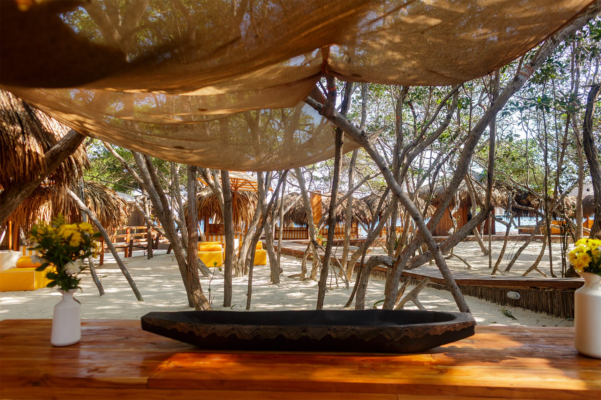 Private island on Isla Grande — beach club dining under umbrellas