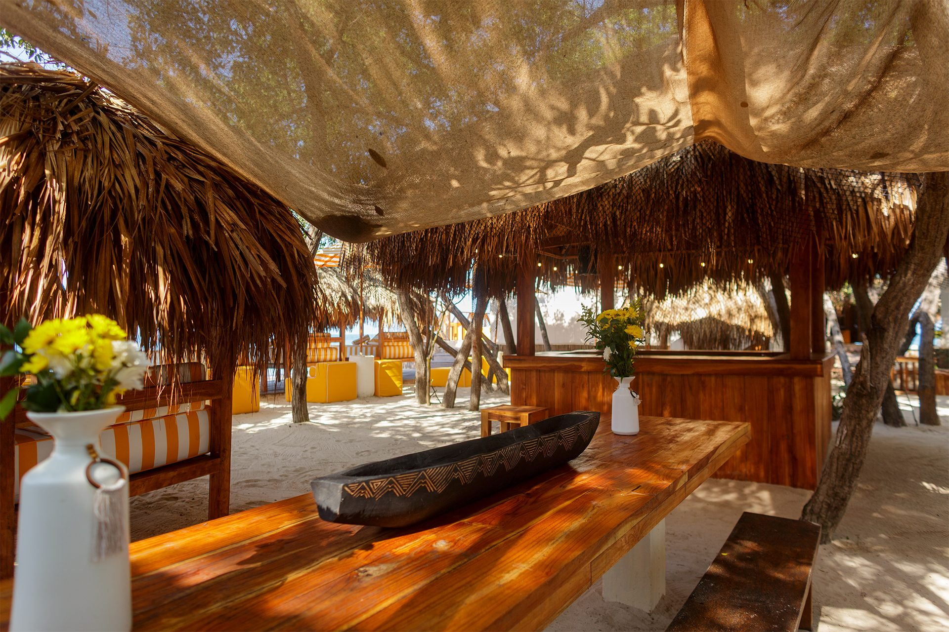 Private island on Isla Grande — beach club dining under umbrellas