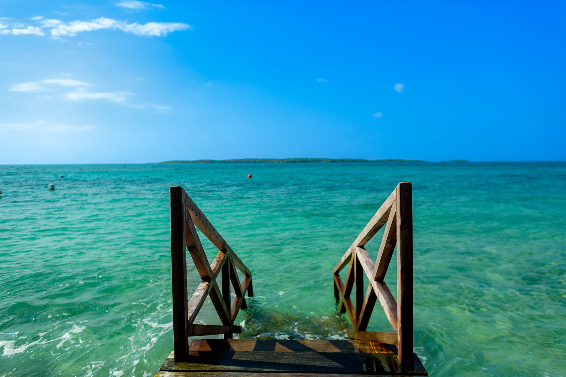 Private island on Isla Grande — beach club dining under umbrellas