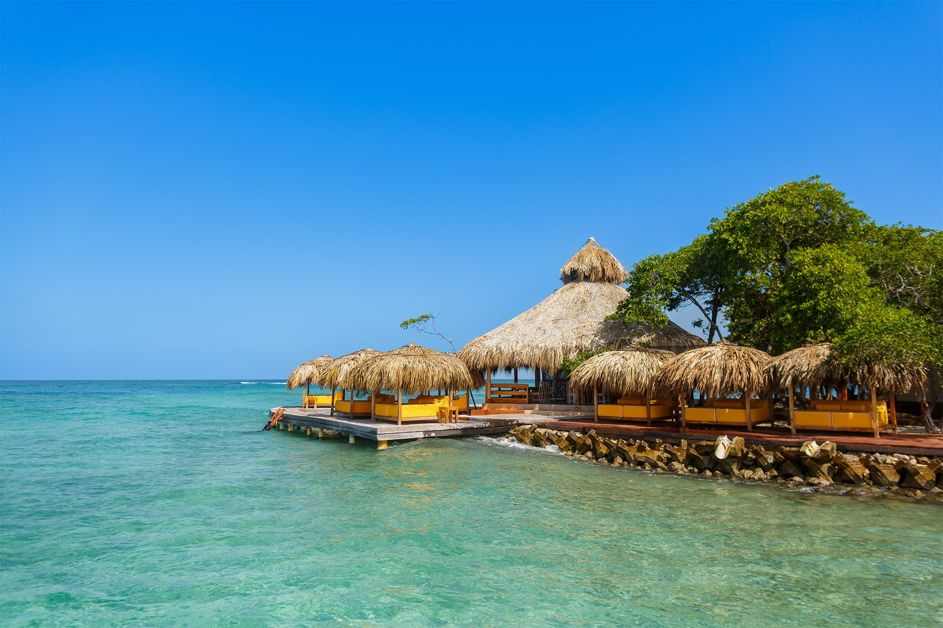 Private island on Isla Grande — beach club dining under umbrellas