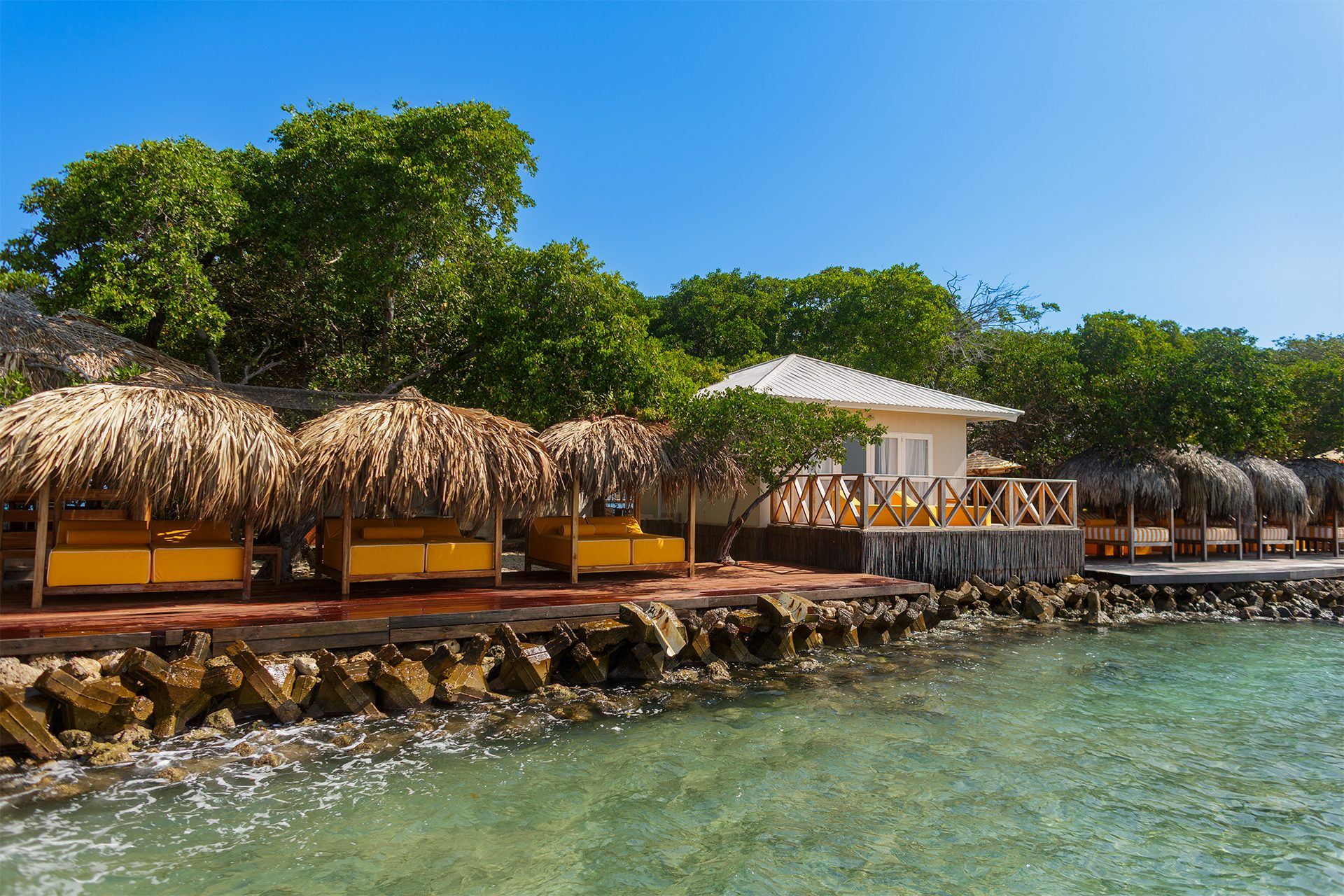 Private island on Isla Grande — beach club dining under umbrellas