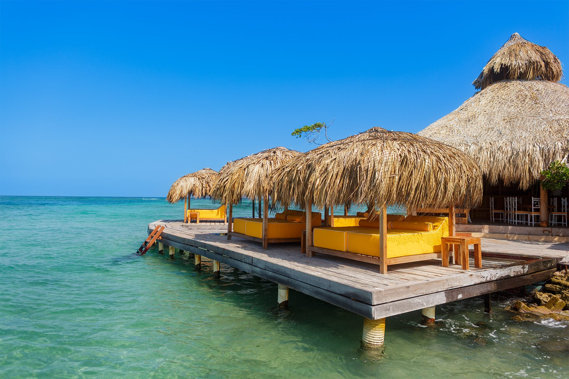 Private island on Isla Grande — beach club dining under umbrellas