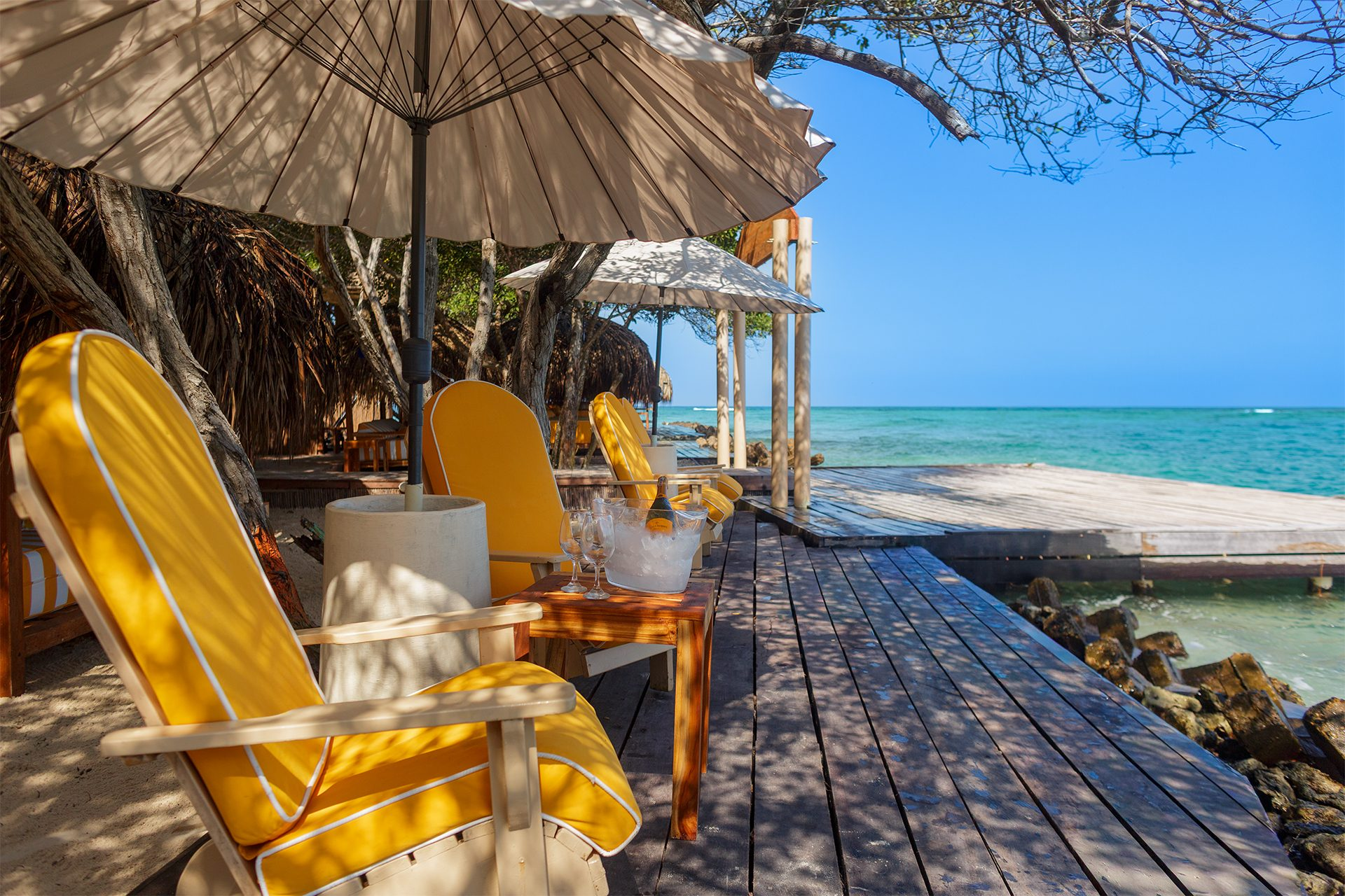 Private island on Isla Grande — beach loungers and palapas by the sea