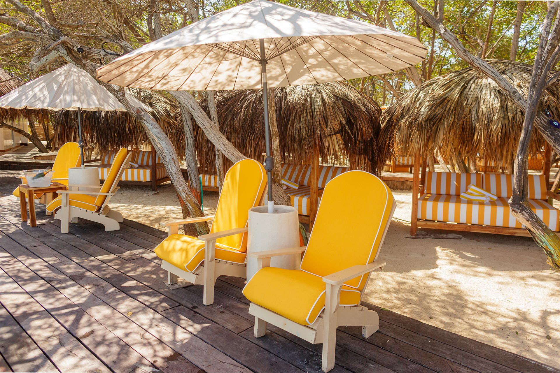 Private island on Isla Grande — beach loungers and palapas by the sea