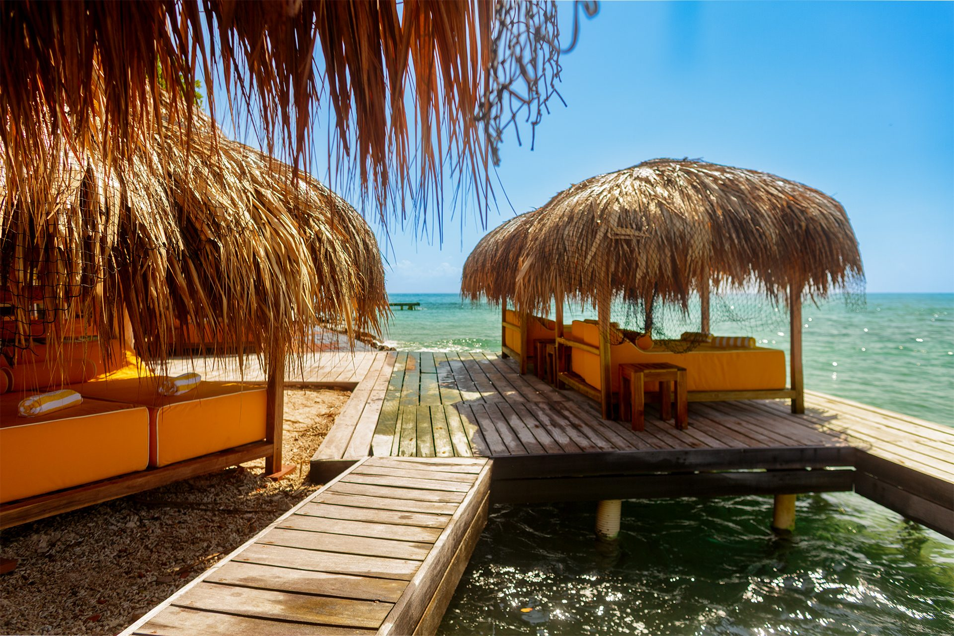 Private island on Isla Grande — beach loungers and palapas by the sea