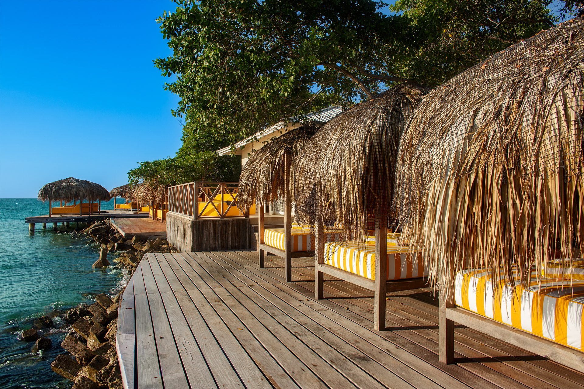 Private island on Isla Grande — shaded palapas and lounge areas