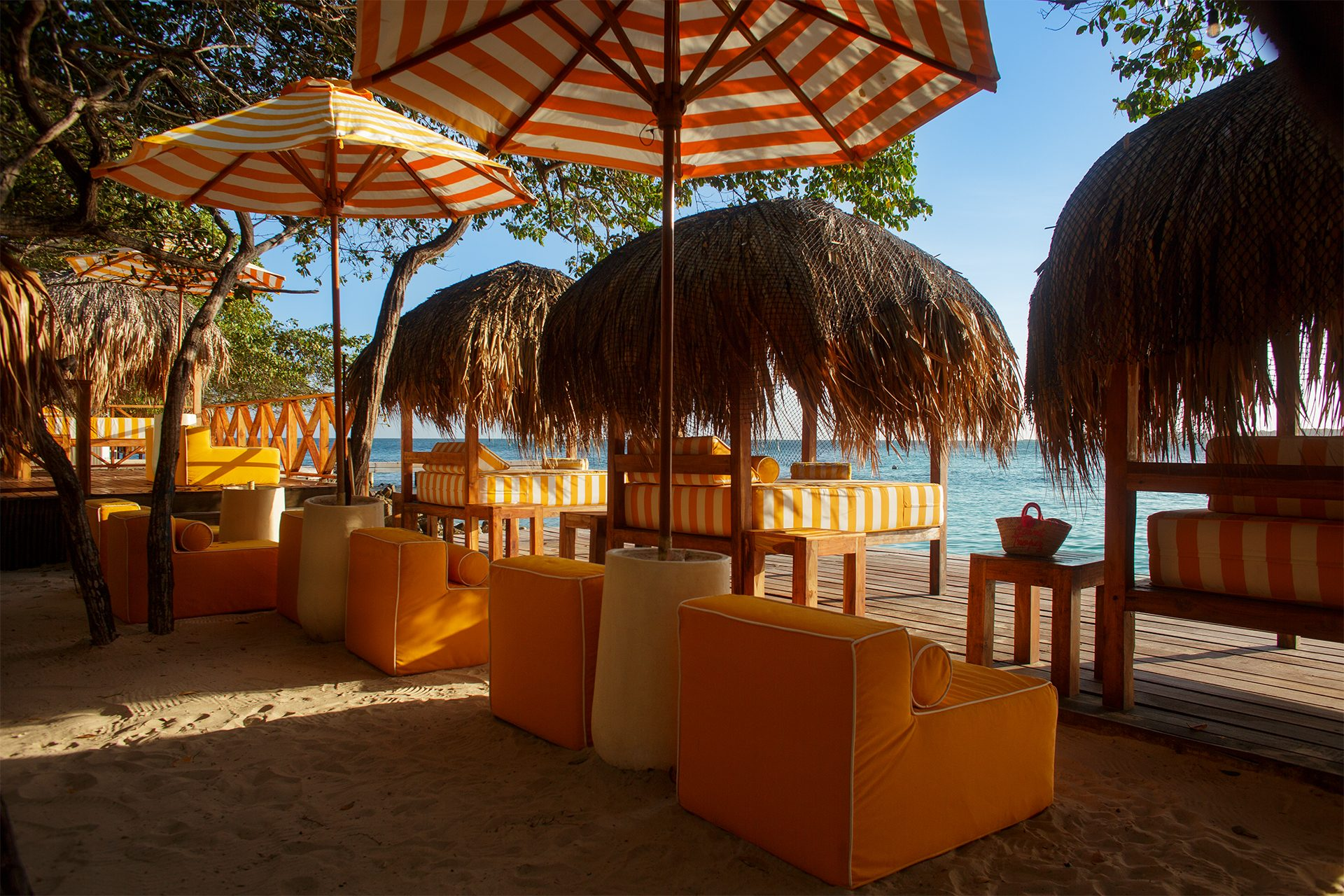 Private island on Isla Grande — shaded palapas and lounge areas