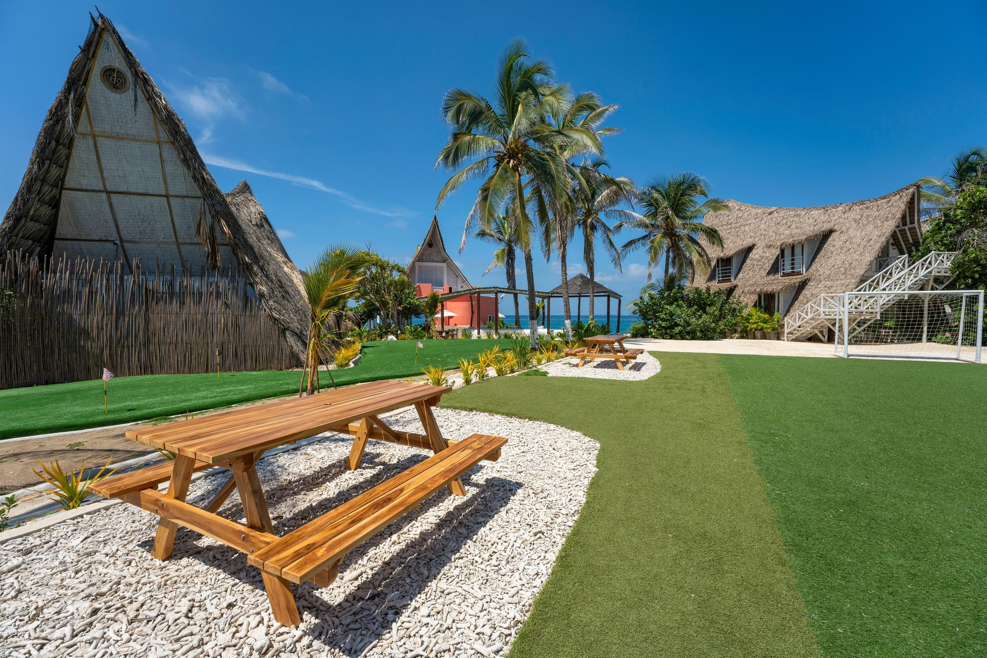 Private villa in the Rosario Islands — garden pathways and pink architecture