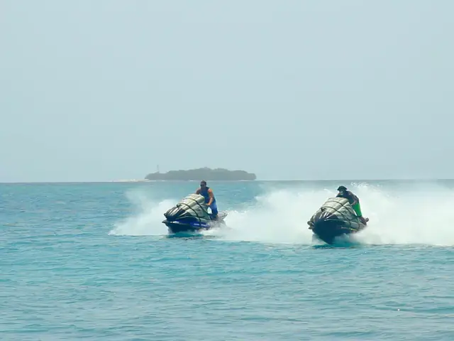 Jet skis throwing spray, then a flyboard rider getting instructions from a jet ski near Cartagena