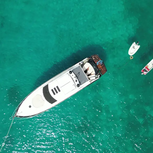 Private yacht anchored in open turquoise water with tenders near Cartagena